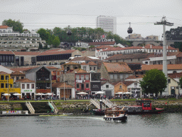 Boats on the Douro river and Vila Nova de Gaia with the Gaia Cable Car, viewed from the Cais da Estiva street