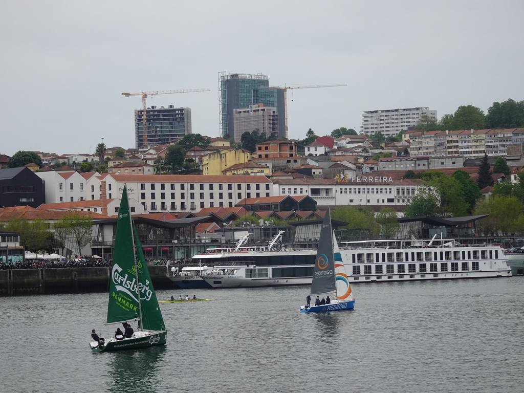 Boats on the Douro river and Vila Nova de Gaia with the Gaia Cable Car, viewed from the Cais da Estiva street