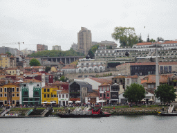 Boats on the Douro river and Vila Nova de Gaia with the Gaia Cable Car, viewed from the Cais da Estiva street