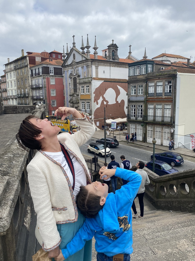 Miaomiao and Max with the Igreja Paroquial de São Nicolau church at the Rua do Infante D. Henrique street