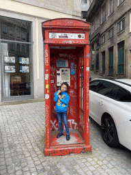 Max in a telephone cell at the crossing of the Rua de São João and Rua de Mouzinho da Silveira streets