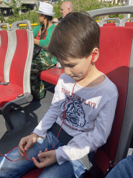 Max with headphones on at the sightseeing bus at the Avenida Dom Afonso Henriques street