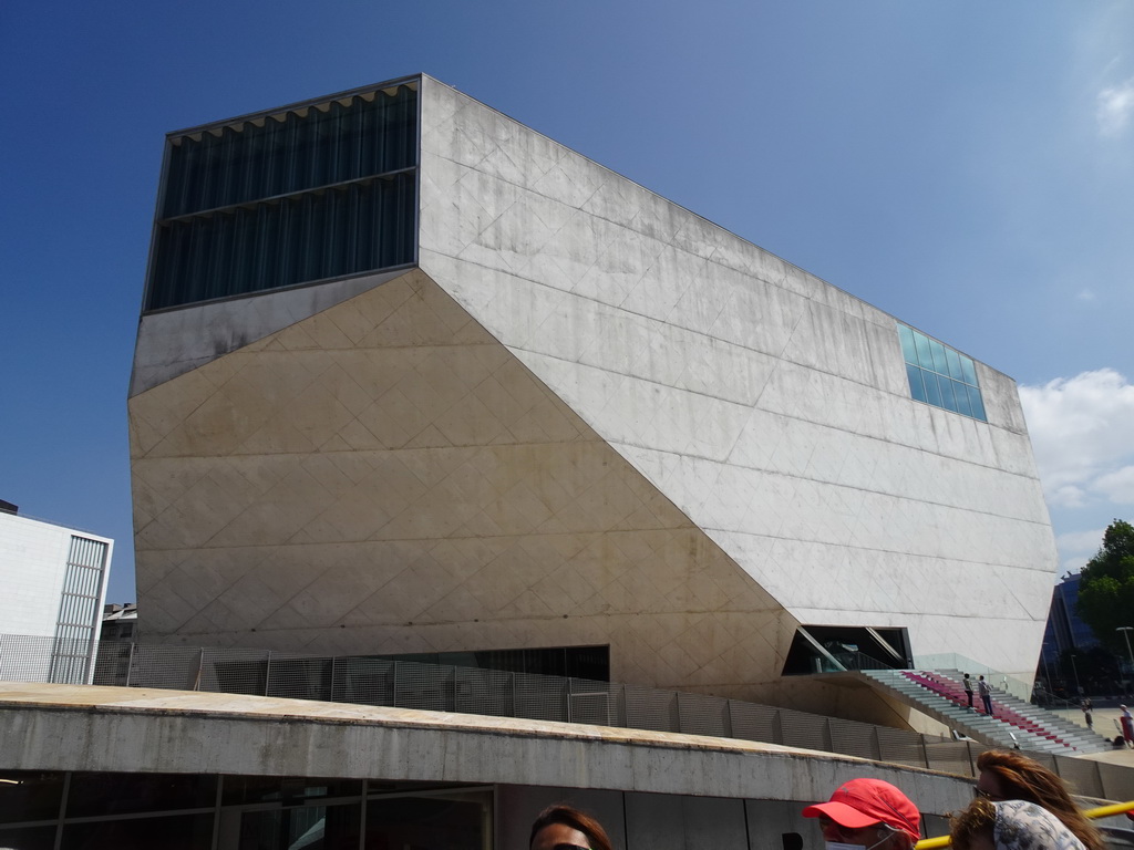 The southwest side of the Casa da Música theatre at the Avenida da Boavista street, viewed from the sightseeing bus