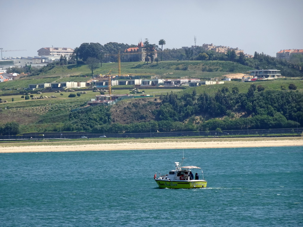 Boat on the Douro river and the west side of Vila Nova de Gaia, viewed from the sightseeing bus on the Avenida de Dom Carlos I street