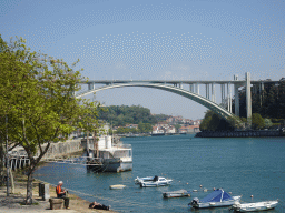 Boats and the Ponte da Arrábida over the Douro river, viewed from the sightseeing bus on the Ria do Ouro street