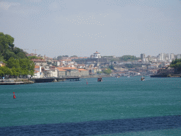 The Alfândega do Porto building, boats on the Douro river and Vila Nova de Gaia with the Mosteiro da Serra do Pilar monastery, viewed from the sightseeing bus