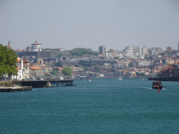 The Alfândega do Porto building, boats on the Douro river and Vila Nova de Gaia with the Mosteiro da Serra do Pilar monastery, viewed from the sightseeing bus