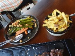 Steak, fries and vegetables at the Cúmplice Steakhouse & Bar