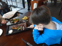 Max eating steak at the Cúmplice Steakhouse & Bar