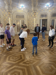 Max helping our tour guide at the east side of the Arab Room at the northwest side of the upper floor of the Palácio da Bolsa palace