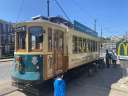 Max in front of an old tram at the Rua do Infante D. Henrique street