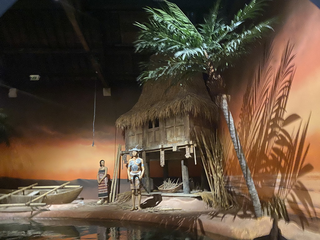 Statues, hut and boat at the Timor and China section of the boat ride at the World of Discoveries museum