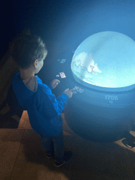 Max with an interactive globe at the Worlds to the World room at the World of Discoveries museum