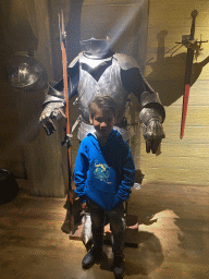 Max with an armour at the On the Deck room at the World of Discoveries museum