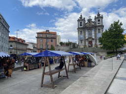Market stalls at the Praça da Batalha square and the front of the Igreja de Santo Ildefonso church