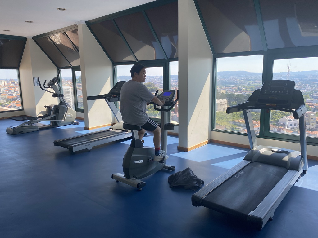 Miaomiao on the home trainer at the fitness room at the Hotel Vila Galé Porto, with a view on the east side of the city