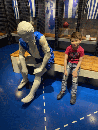 Max with a statue of a football player at the FC Porto Museum at the Estádio do Dragão stadium