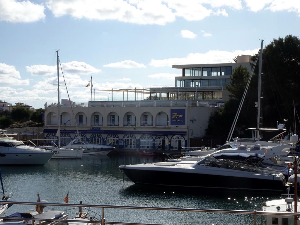 Boats in the northeast side of the harbour and the Club Náutico Porto Cristo, viewed from the Carretera del Moll street