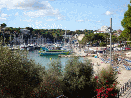 The Playa de Porto Cristo beach and boats in the southeast side of the harbour, viewed from the Carrer d`En Bordils street