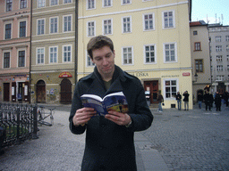 Tim with the Lonely Planet guide of Prague, at Old Town Square