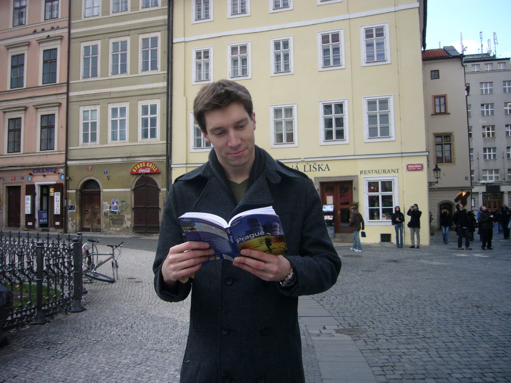 Tim with the Lonely Planet guide of Prague, at Old Town Square