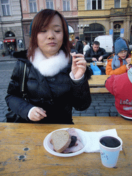 Miaomiao eating meat and drinking glühwein at Old Town Square