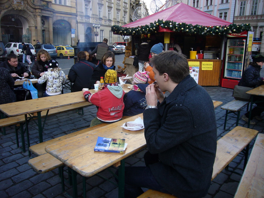 Tim eating meat and drinking glühwein at Old Town Square