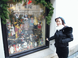 Miaomiao at a shopping window with wooden dolls