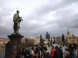 The statue of St. John of Nepomuk, Charles Bridge, St. Francis Seraphinus Church and the Old Town Bridge Tower