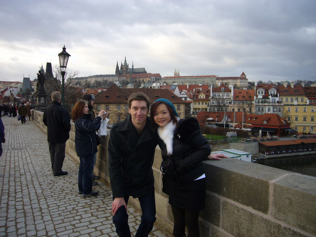 Tim and Miaomiao at Charles Bridge, with the Prague Castle and the St. Vitus Cathedral