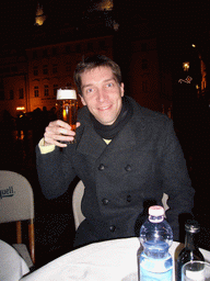 Tim with a beer on the Old Town Square, at christmas night