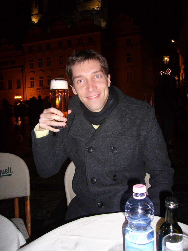 Tim with a beer on the Old Town Square, at christmas night