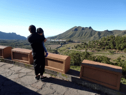 Miaomiao and Max at a parking place along the TF-82 road, with a view on the town of Santiago del Teide and hills on the west side of the island