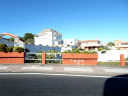 Houses at the west side of the town of El Tanque, viewed from the rental car on the Avenida Príncipes de España street