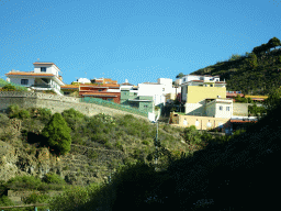 Houses on the east side of the town of Icod de los Vinos, viewed from the rental car on a roundabout at the crossing of the TF-5 and TF-42 roads
