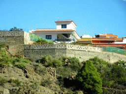 Houses on the east side of the town of Icod de los Vinos, viewed from the rental car on a roundabout at the crossing of the TF-5 and TF-42 roads