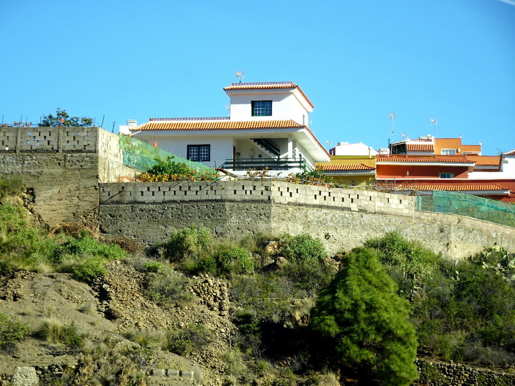 Houses on the east side of the town of Icod de los Vinos, viewed from the rental car on a roundabout at the crossing of the TF-5 and TF-42 roads