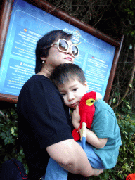 Miaomiao and Max with a parrot toy in front of a sign of the Discovery Tour at the Loro Parque zoo, during the Discovery Tour