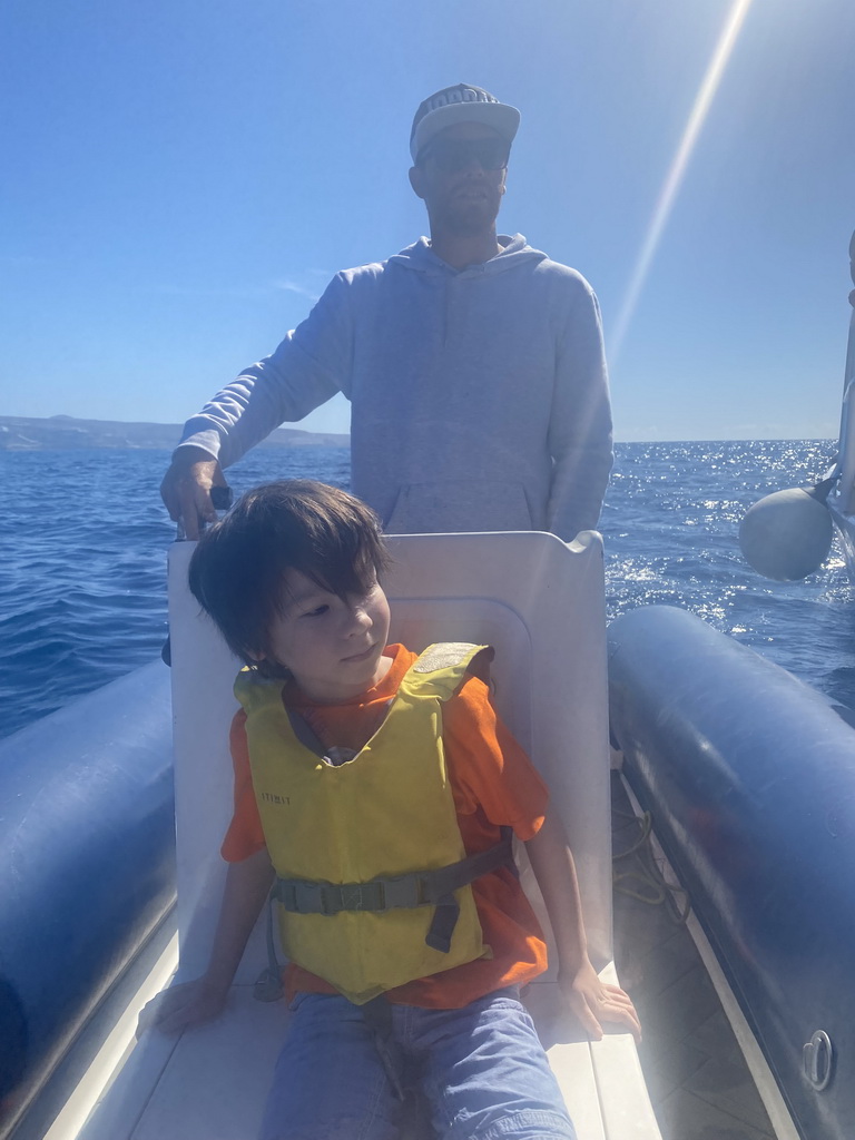 Max and our guide on a small boat from the Sagitarius Cat boat to the jet ski