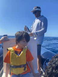 Max and our guide on a small boat from the Sagitarius Cat boat to the jet ski