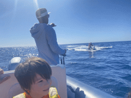 Max and our guide on a small boat from the Sagitarius Cat boat to the jet ski