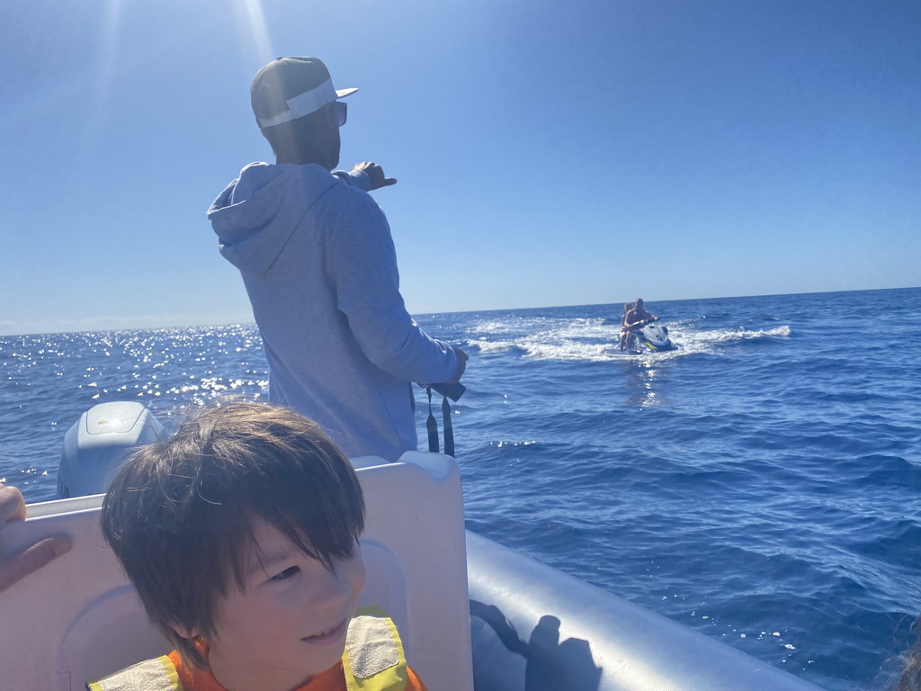 Max and our guide on a small boat from the Sagitarius Cat boat to the jet ski