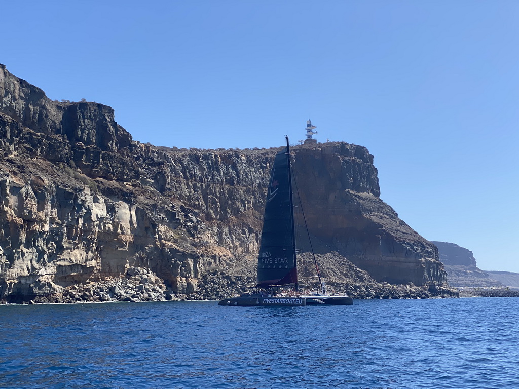 Boat in front of the coastline, viewed from the Sagitarius Cat boat