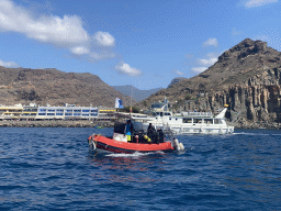 Boats in front of the Playa Puerto De Mogan beach, viewed from the Sagitarius Cat boat