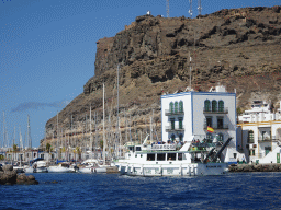 Boat in front of the harbour and the Hotel THe Puerto de Mogán, viewed from the Sagitarius Cat boat