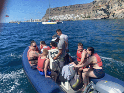 Small boat from the Sagitarius Cat boat to the parasail, in front of the town center with the pavilion of Beach Club Faro, the harbour and the Hotel THe Puerto de Mogán, viewed from the Sagitarius Cat boat