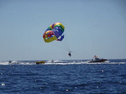 Parasail, jet skis and boat, viewed from the Sagitarius Cat boat