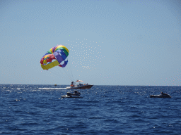 Parasail and jet skis, viewed from the Sagitarius Cat boat