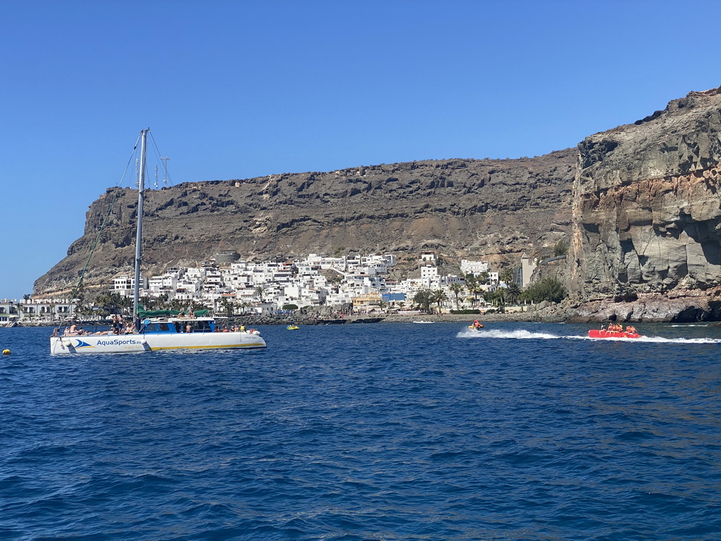 Boat, jet ski and banana boat in front of the town center, viewed from the Sagitarius Cat boat