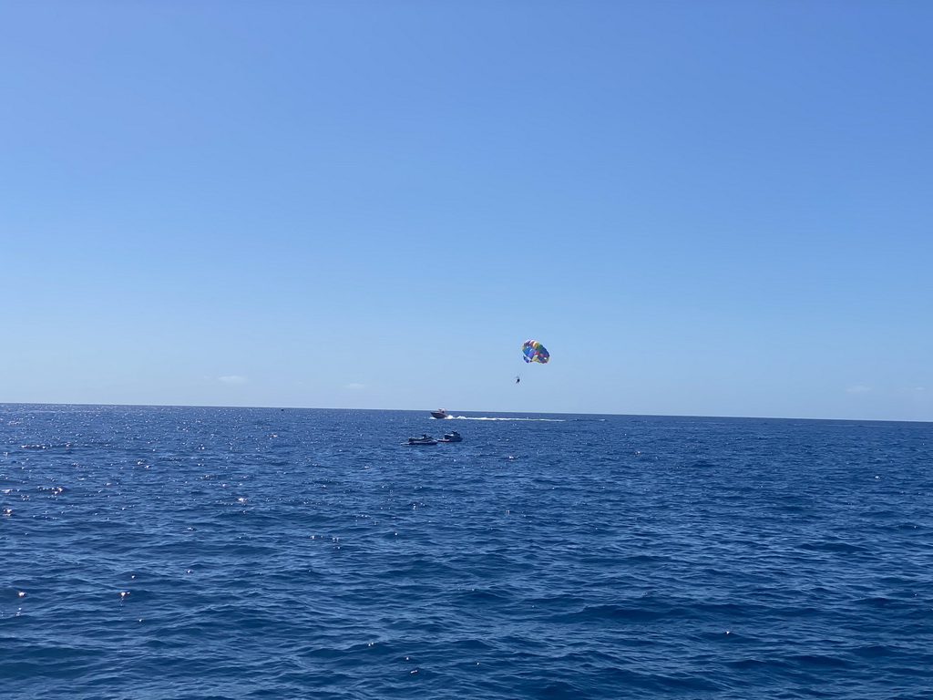Parasail and jet skis, viewed from the Sagitarius Cat boat